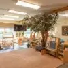Natural Pod classroom with Evergreen Shelving and Reach Tables, featuring plants and biophilic design elements.