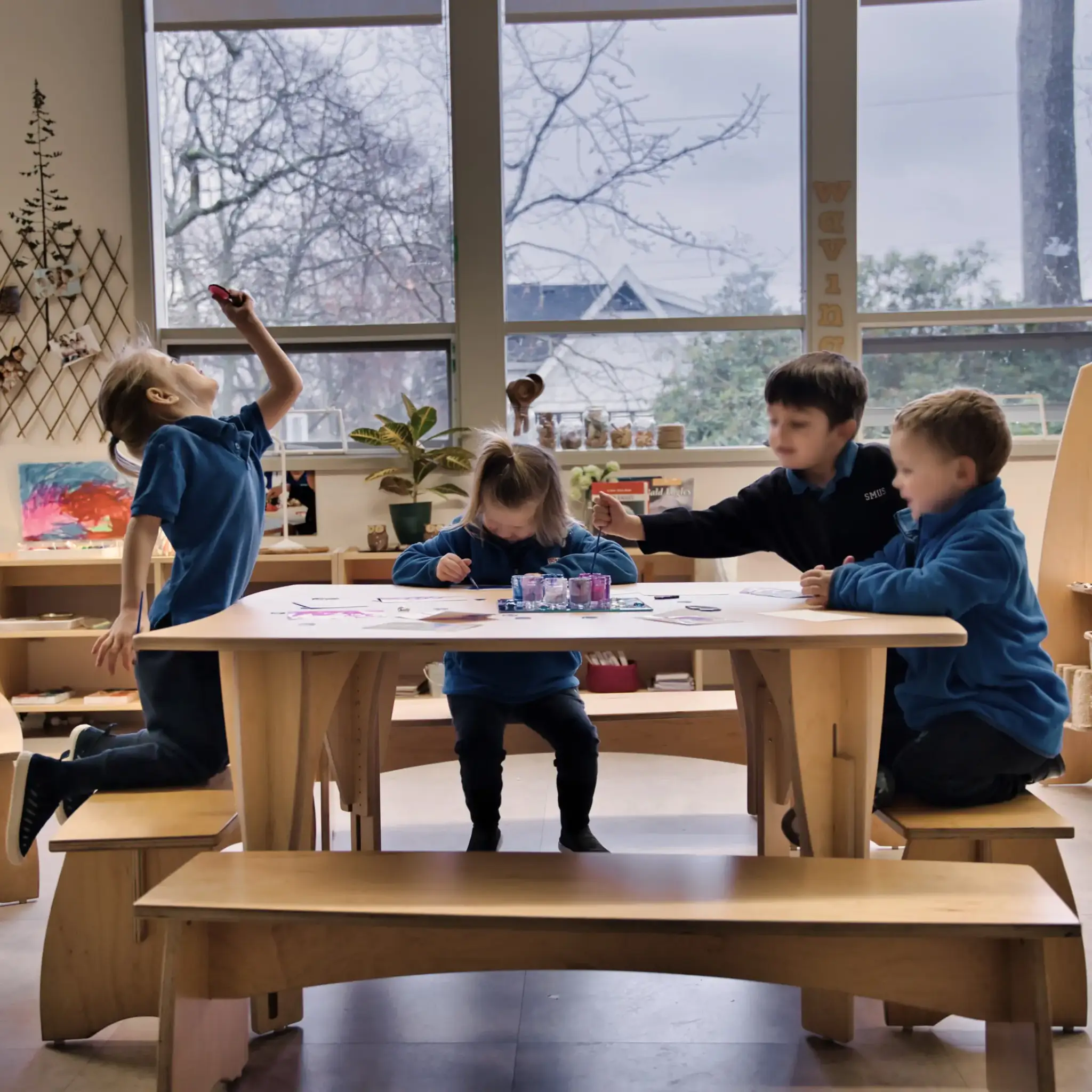 Children working on art projects on top of the Sprig Table by Natural Pod