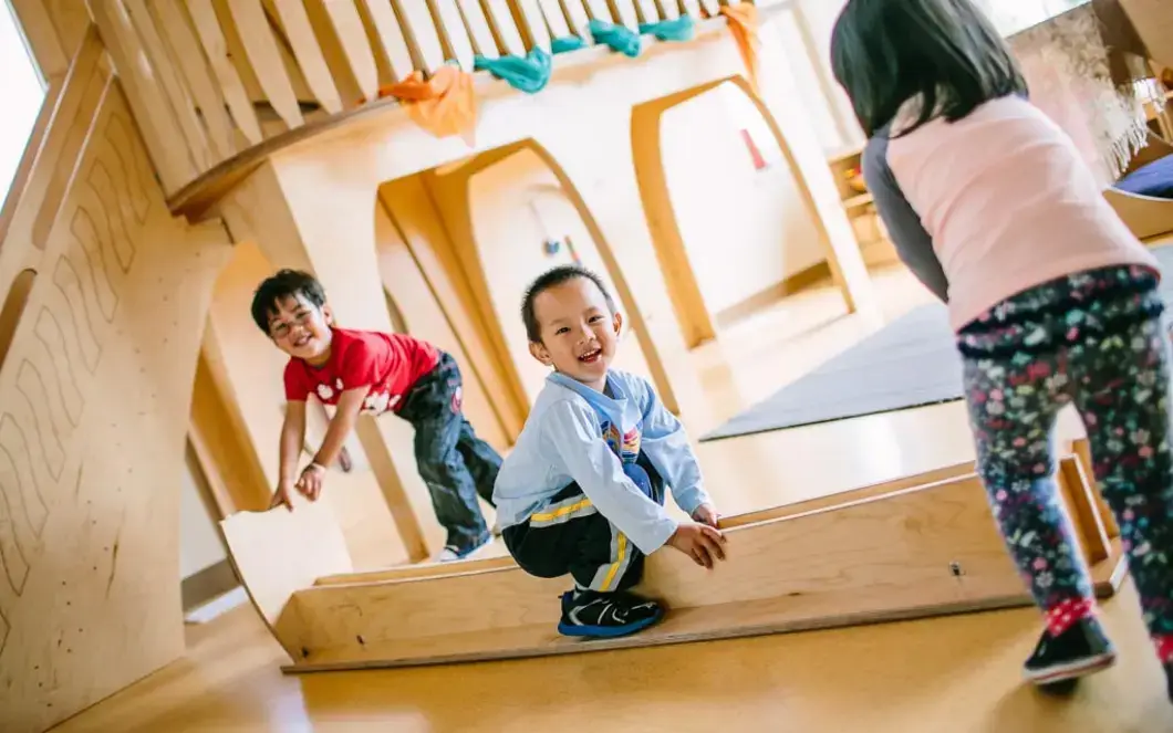 Children use a Natural Pod Share Bench in a creative and imaginative way.