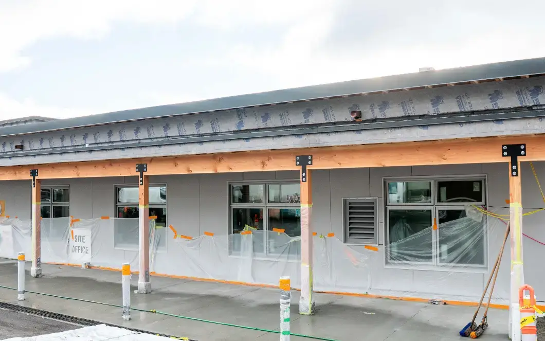 Exterior of the West Vancouver Schools Early Childhood Education Centre under construction featuring exposed wood beams.