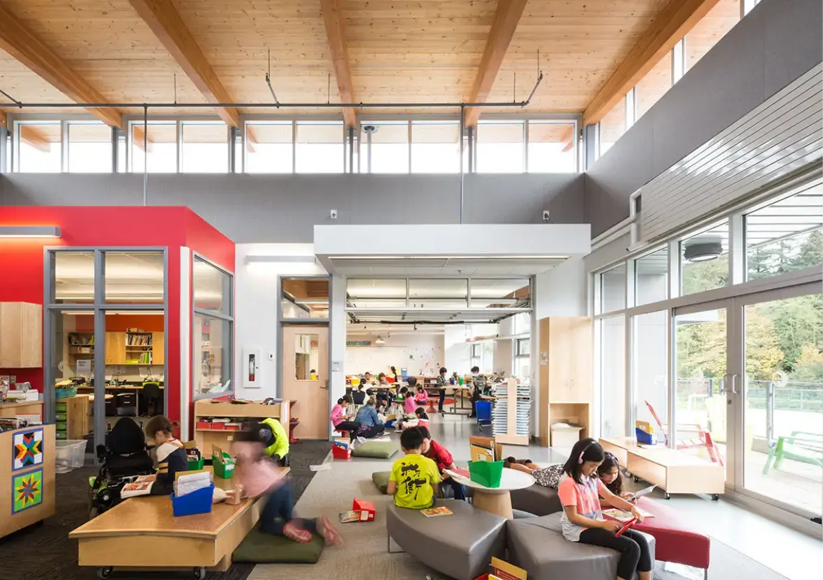 Children reading independently on soft modular cushions within a student-centered learning environment.