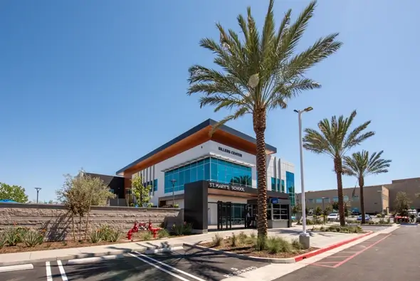 Exterior view of St. Mary’s School with palm trees and modern architecture.