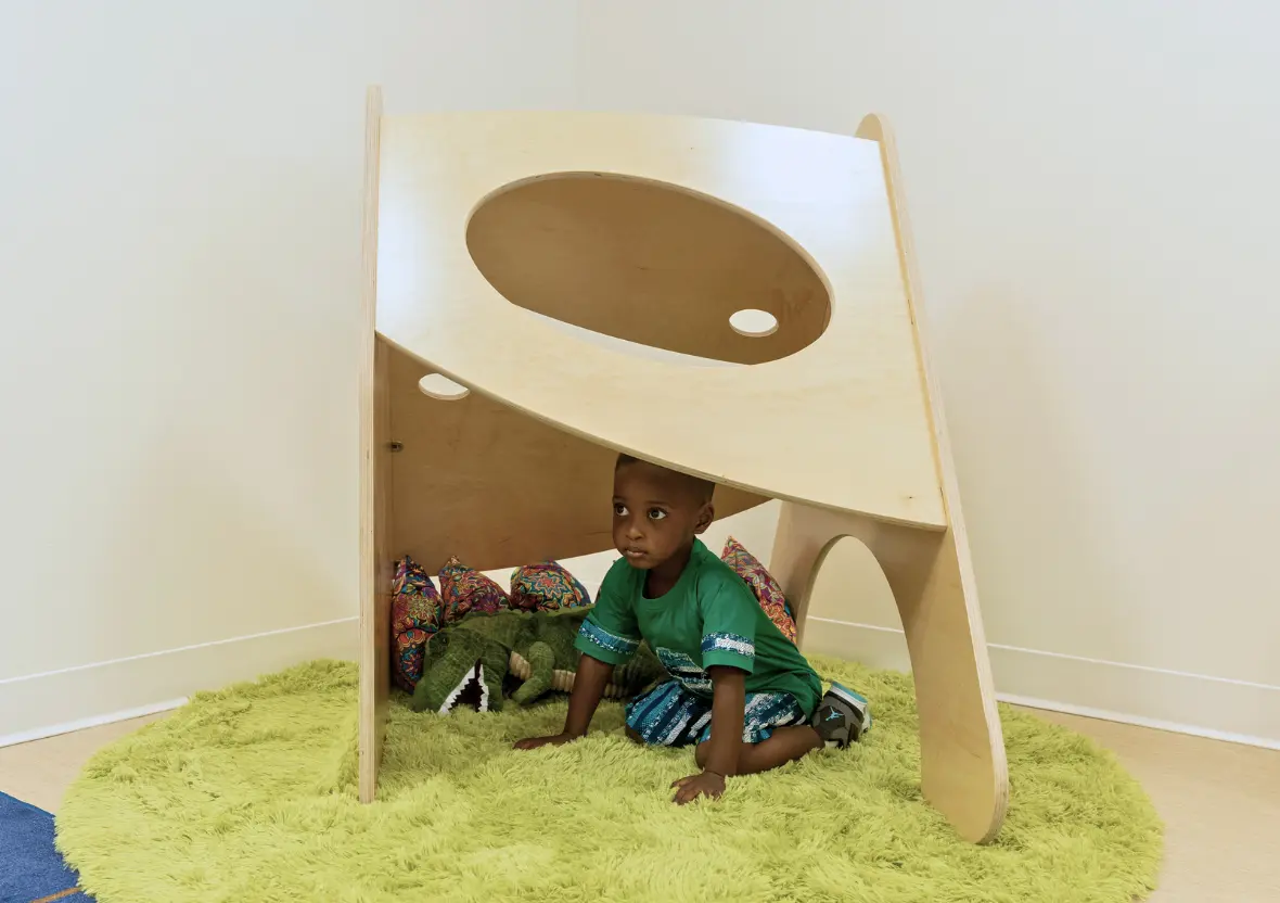 A child explores underneath a Natural Pod nook