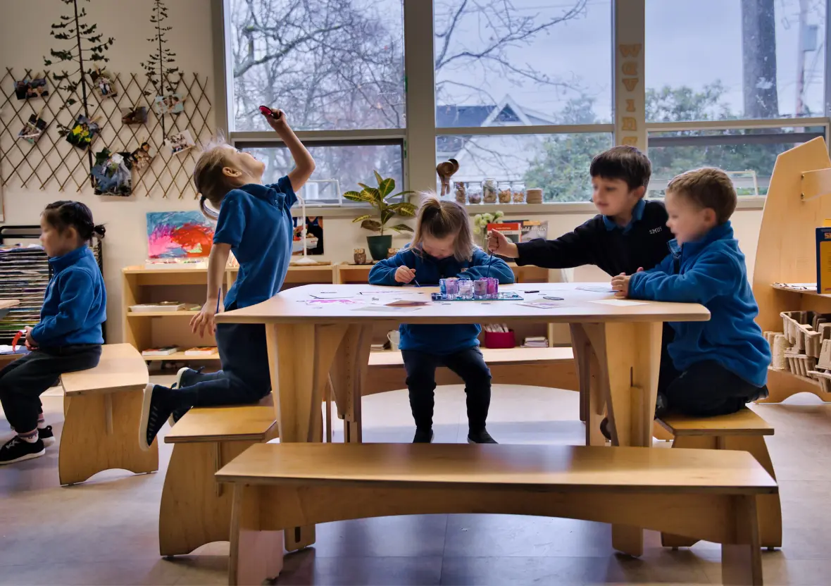 Learners sitting at the Sprig classroom table