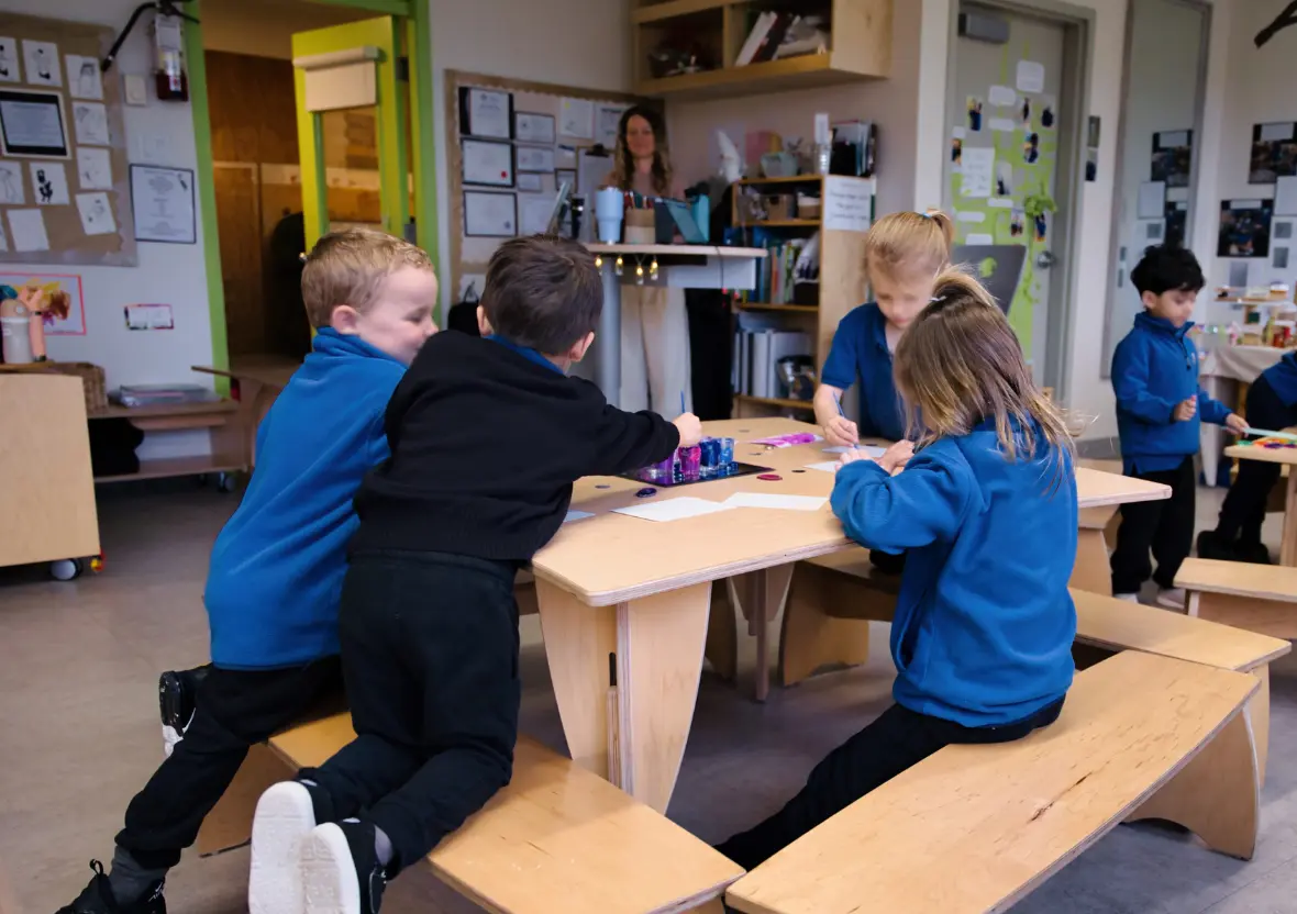 Children painting at a Sprig Table