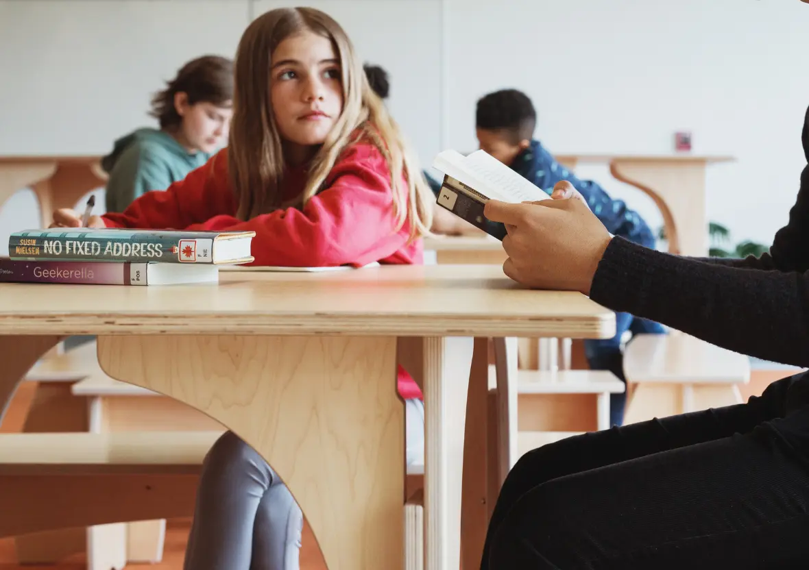 A young girl sits at a table in a sustainable learning space