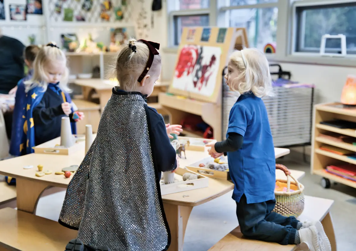 Children kneeling on benches in an intentionally designed learning space.