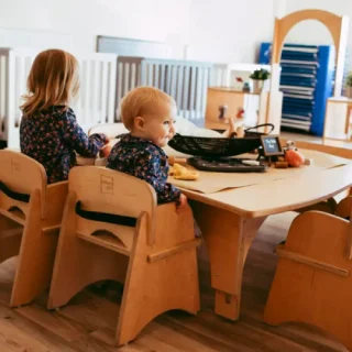 Childcare-EarlyLearning-sq CHILDCARE + EARLY LEARNING: Infants on Natural Pod FSC Certified wooden chairs and table playing and reading.