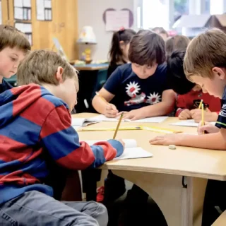 Elementary-School-sq ELEMENTARY SCHOOL: Elementary school students working independently on Natural Pod's standing desk. Natural Pod Gather Tables with their crescent curved shaped surfaces, bring together function and versatility.